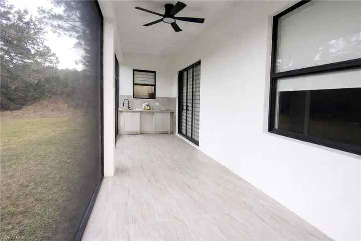 View of patio with an outdoor kitchen and a ceiling fan