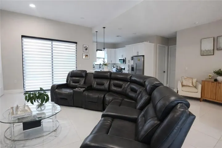 Living area featuring recessed lighting and light tile patterned flooring