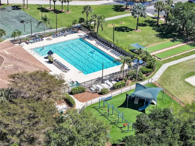 Community amenities featuring a large swimming pool, surrounding lounge area, and adjacent sports courts