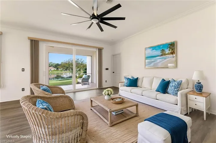 Spacious interior with wood-finish flooring and a contemporary ceiling fan