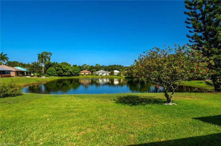 Expansive green lawn bordering a tranquil pond