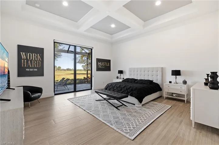 Bedroom featuring coffered ceiling, access to exterior, light wood-type flooring, and recessed lighting