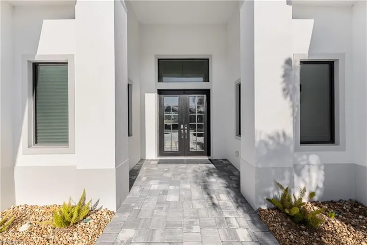 Entrance to property with french doors and stucco siding