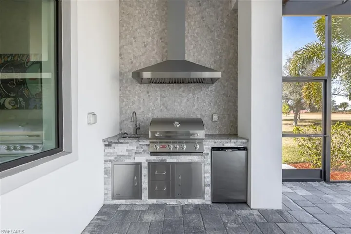 View of patio / terrace with an outdoor kitchen and a sink