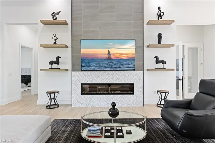 Living area featuring light wood finished floors and a tile fireplace