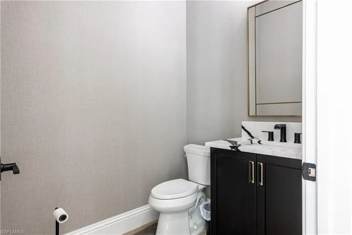 Half bathroom with vanity and toilet