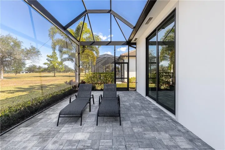 View of patio / terrace featuring glass enclosure and a sunroom