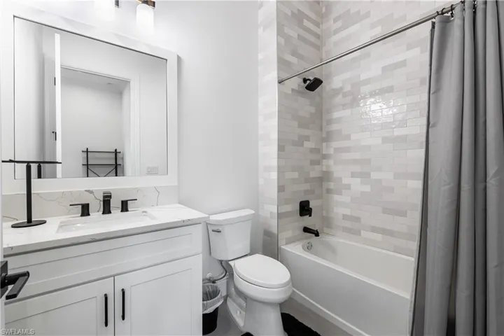 Full bathroom featuring shower / bathtub combination with curtain and vanity