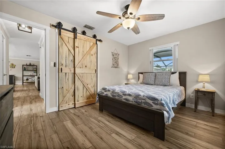 Bedroom with wood finished floors and a ceiling fan