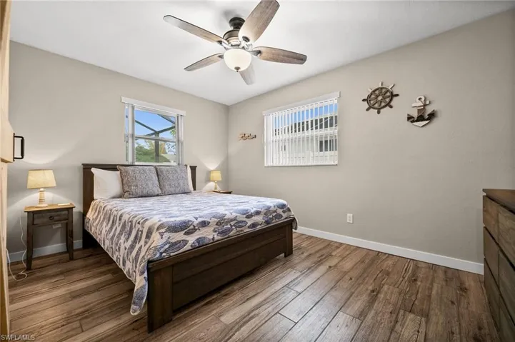 Bedroom with wood finished floors and ceiling fan