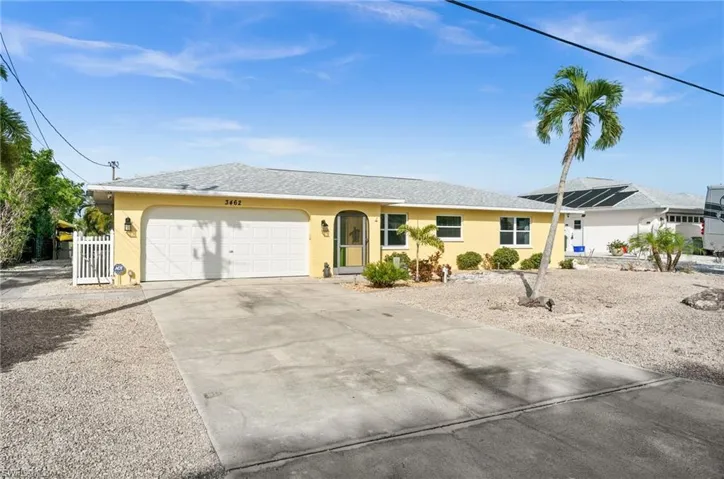 Single story home featuring stucco siding, driveway, an attached garage, and a shingled roof