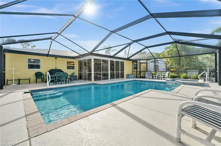 View of pool with a patio, a sunroom, and a lanai