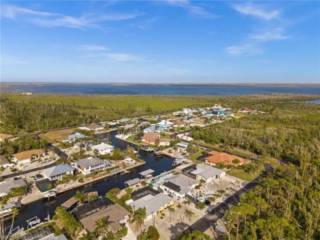 Aerial overview of property's location with a large body of water