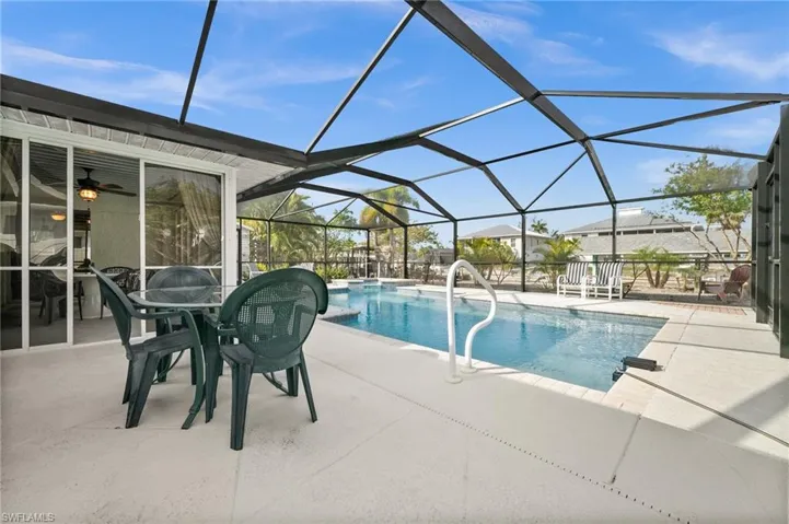 Outdoor pool featuring a sunroom, a patio, and a lanai