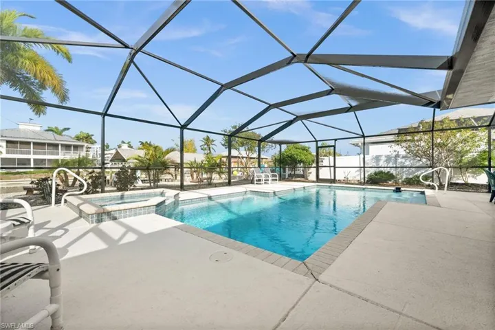 View of pool featuring a sunroom, a patio, a pool with connected hot tub, and a lanai
