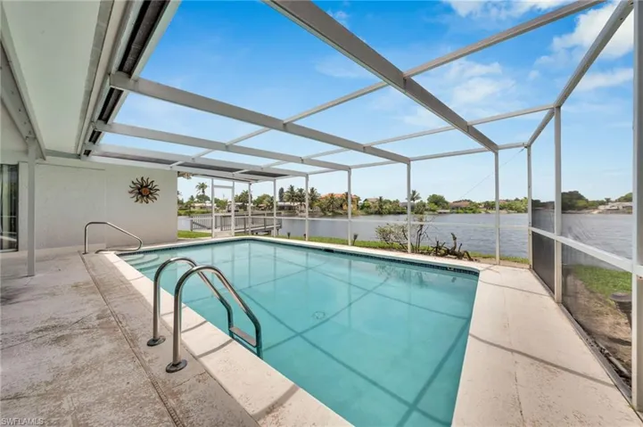 Screened swimming pool with integrated steps and stainless steel handrails
