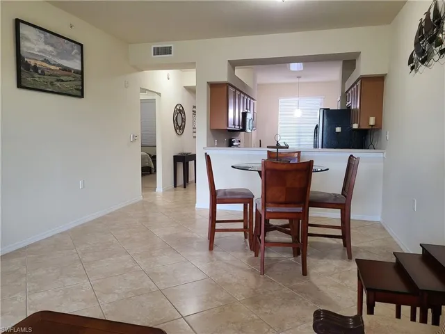 Dining space featuring baseboards and light tile patterned floors