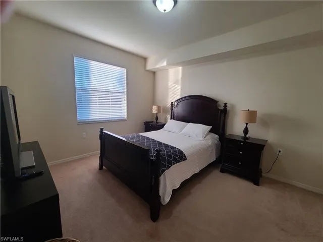 Bedroom featuring carpet floors and baseboards
