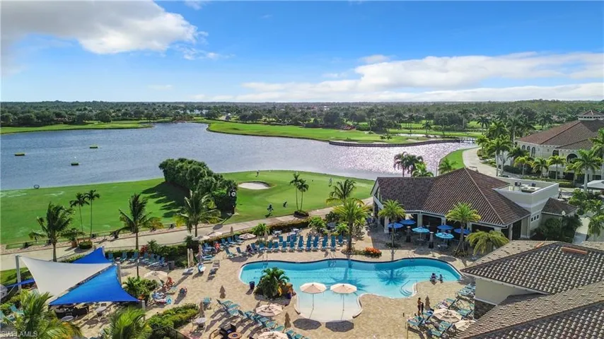 Community pool featuring a patio area, golf course view, and a water view