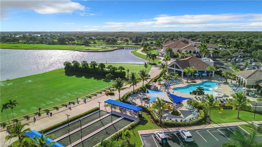 Aerial view of a pool area and a nearby body of water