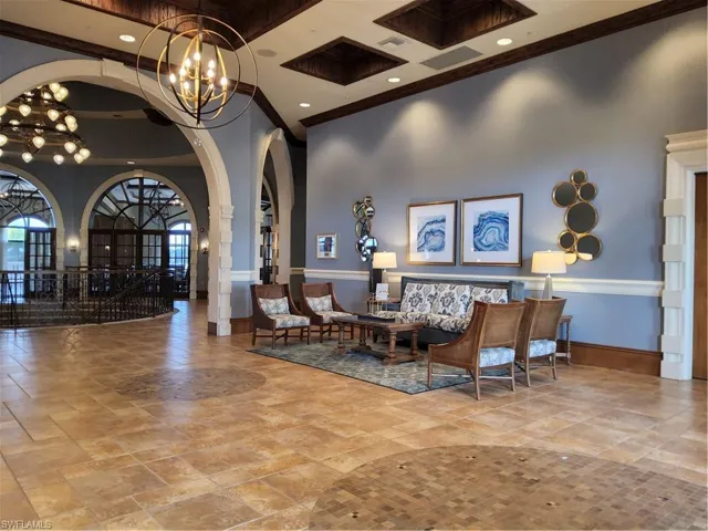 Lobby featuring ornamental molding, a high ceiling, and recessed lighting