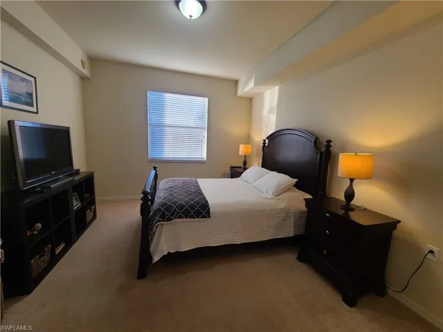 Carpeted bedroom featuring baseboards