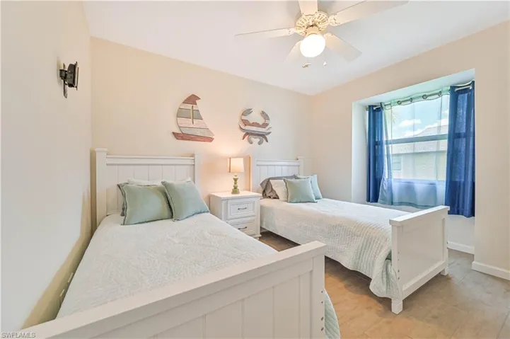 Bedroom with light wood-type flooring and a ceiling fan