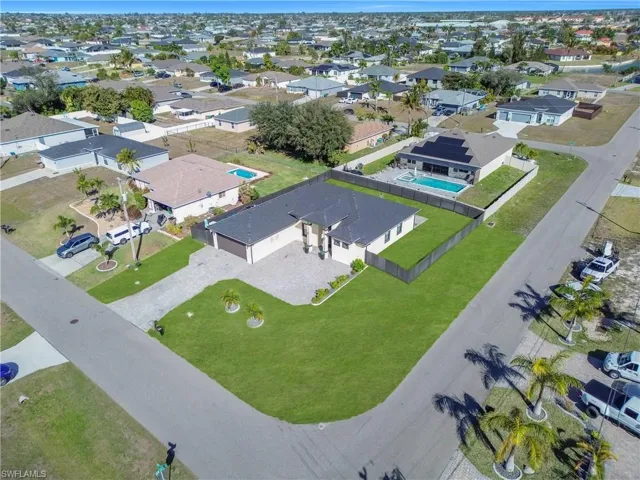 Aerial perspective of suburban area with a pool