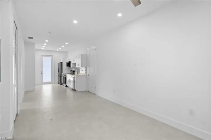 Unfurnished living room with recessed lighting and light flooring