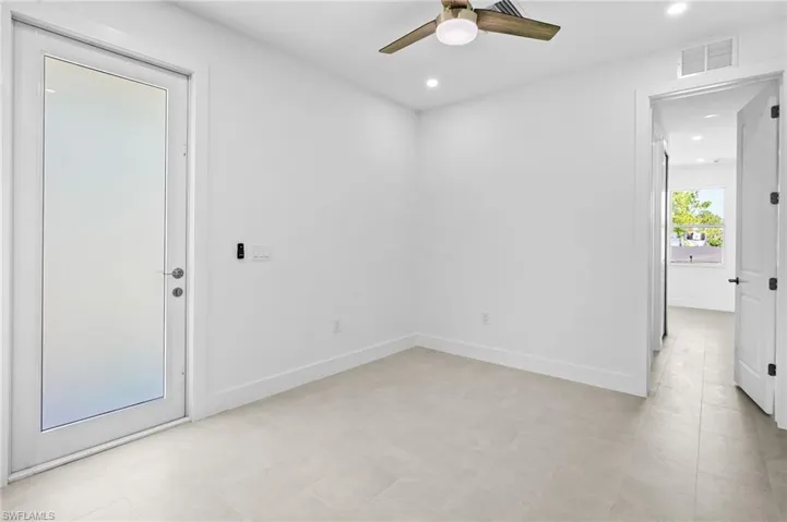Empty room with recessed lighting and a ceiling fan
