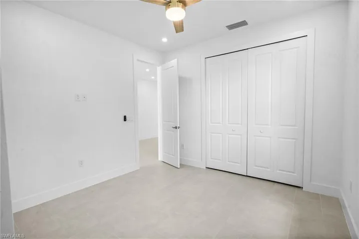 Unfurnished bedroom with a ceiling fan, recessed lighting, and a closet