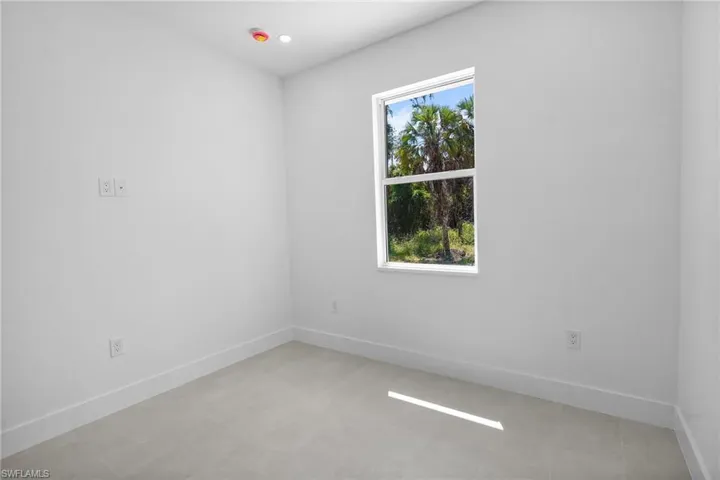Empty room with baseboards and recessed lighting