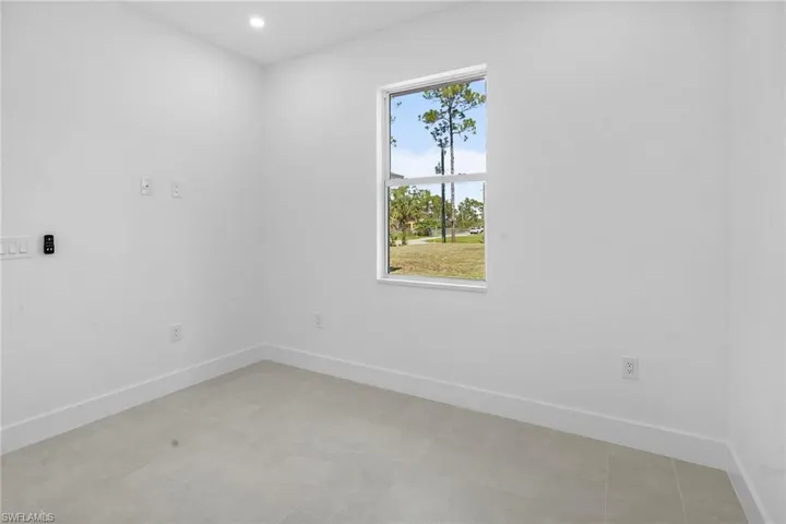 Empty room featuring baseboards and recessed lighting