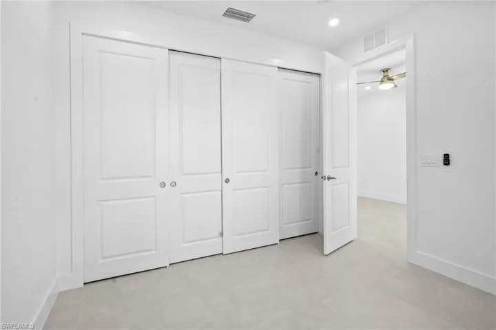 Unfurnished bedroom with a closet and recessed lighting