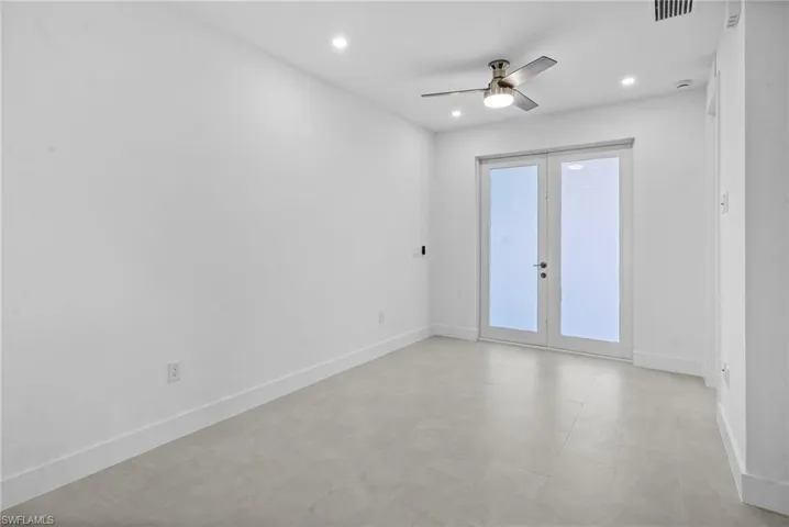 Spare room with a ceiling fan, french doors, and recessed lighting