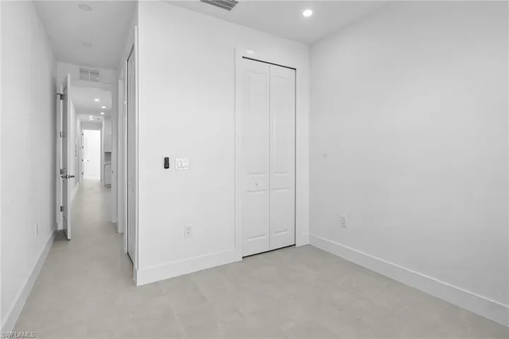 Unfurnished bedroom with recessed lighting and a closet