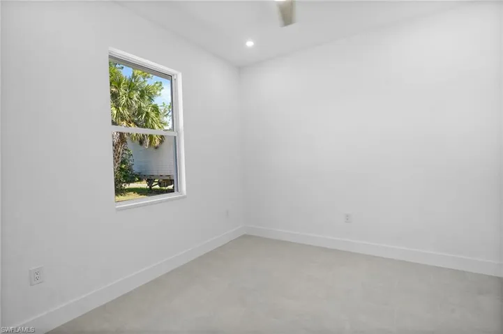 Empty room featuring baseboards and recessed lighting