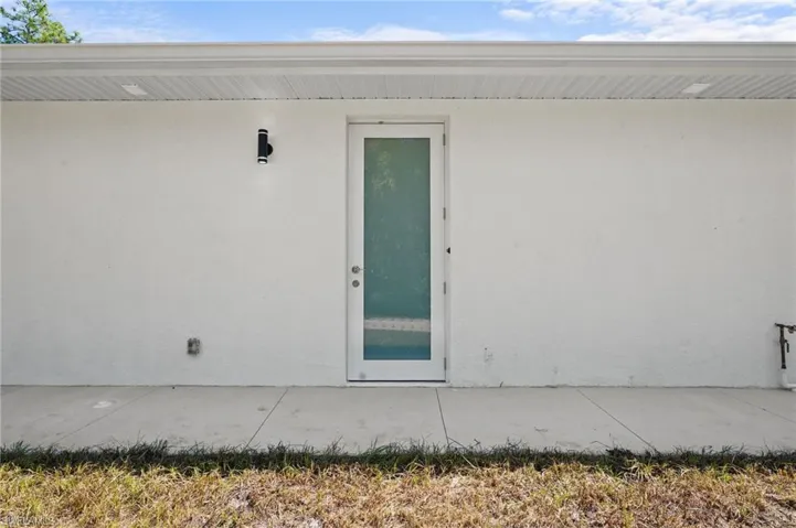 Entrance to property with stucco siding