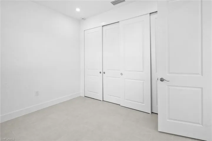Unfurnished bedroom with recessed lighting and a closet