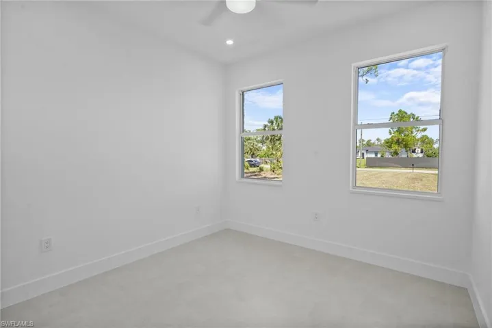 Empty room featuring a ceiling fan and recessed lighting