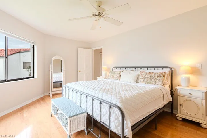 Bedroom featuring ceiling fan and hardwood / wood-style flooring