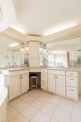 Bathroom featuring tile patterned floors, separate shower and tub, and vanity