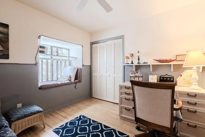 Office space with ceiling fan and wood-type flooring