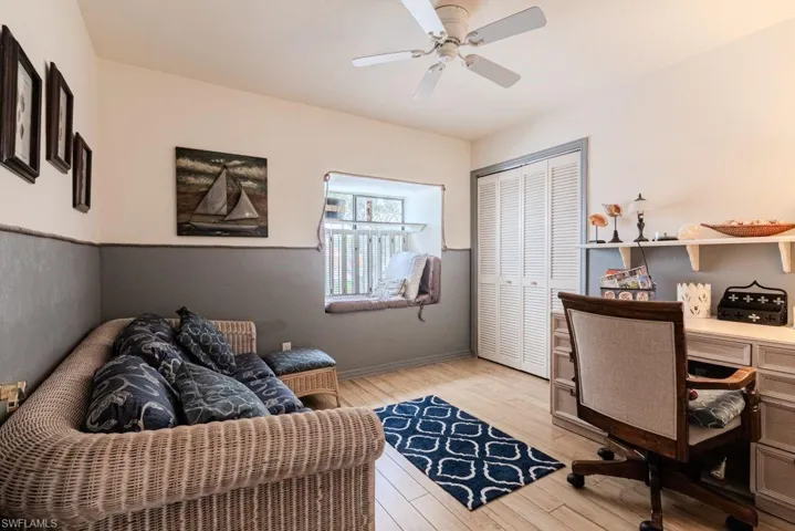 Office space featuring ceiling fan and light hardwood / wood-style flooring