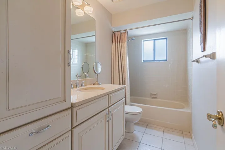 Full bathroom featuring tile patterned floors, shower / tub combo with curtain, vanity, and toilet
