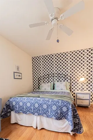 Bedroom featuring hardwood / wood-style flooring and ceiling fan