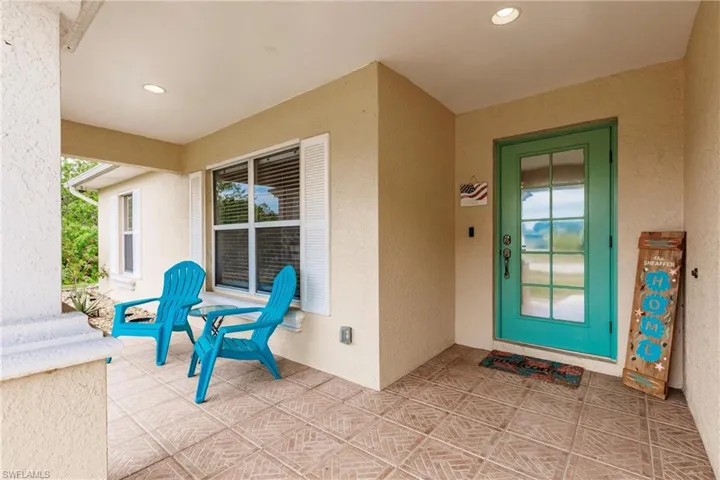 Entrance to property with stucco siding