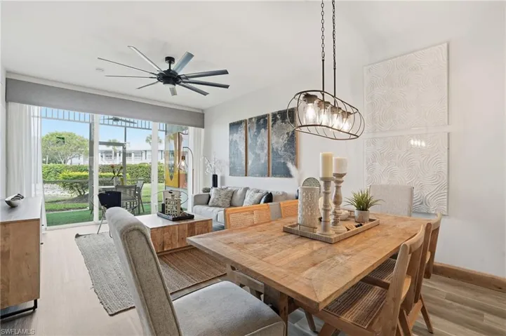 Dining room with light wood-style floors and ceiling fan