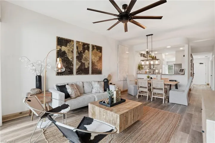 Living area with wood finished floors, ceiling fan, and recessed lighting