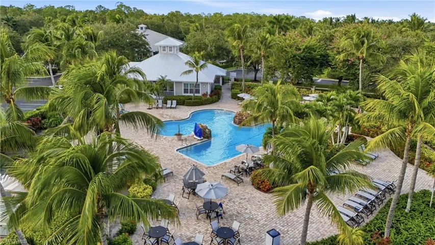 Community pool featuring a patio area and outdoor dining space
